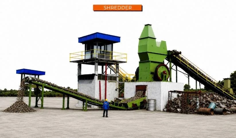 Impact hammer shredder installation with feed conveyor and control cabin at a scrap processing yard
